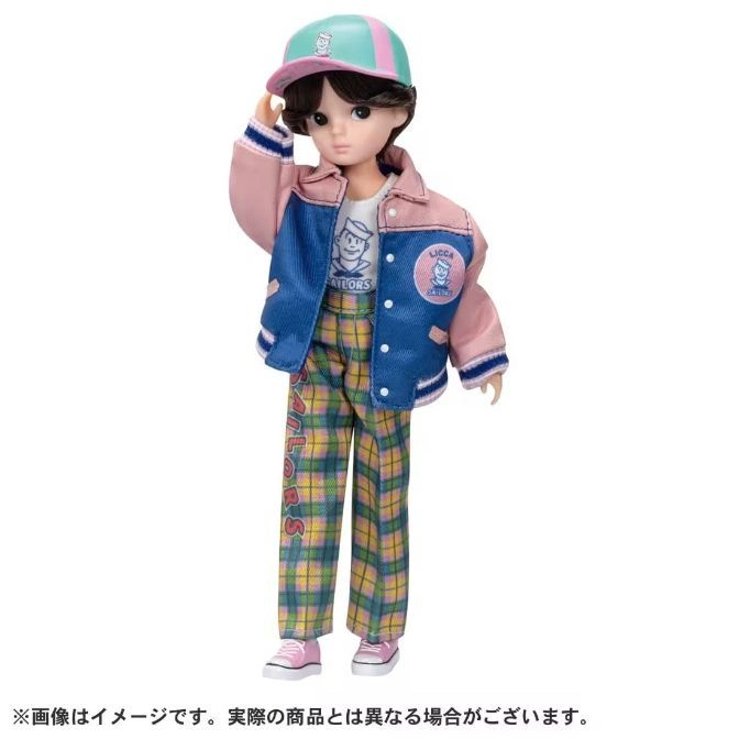 Licca-chan doll in a pink and blue jacket, plaid pants, and a cap, striking a pose.