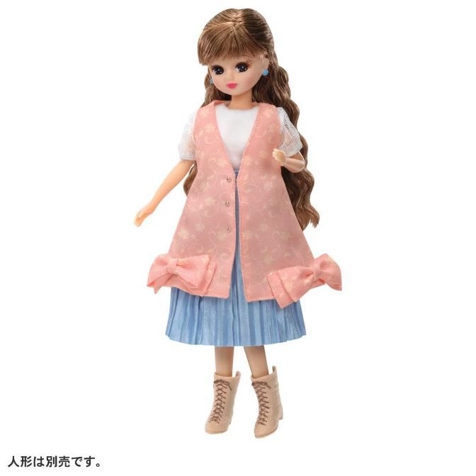  Doll with pink vest, blue skirt, and tan boots.