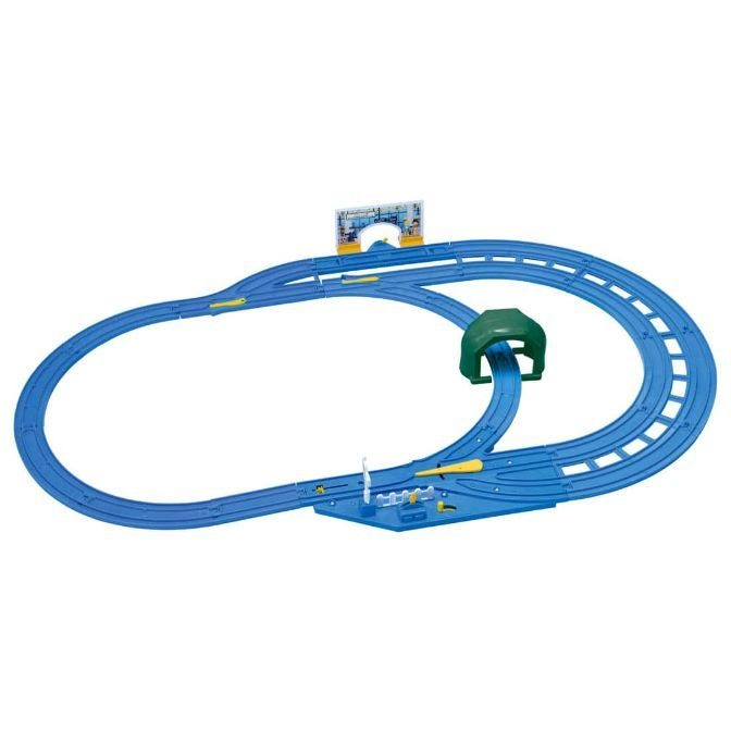 A blue toy train track set with a green tunnel and a station.