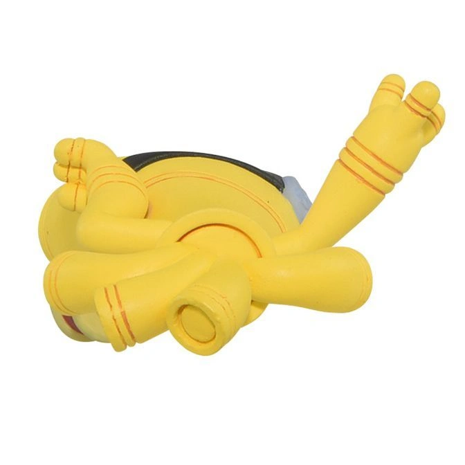  Yellow Minion toy lying on its back with arms and legs raised.
