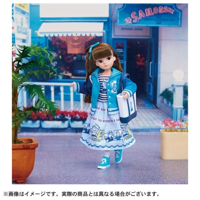  Jenny doll in a sailor-themed outfit with a bag, standing in front of a shop.