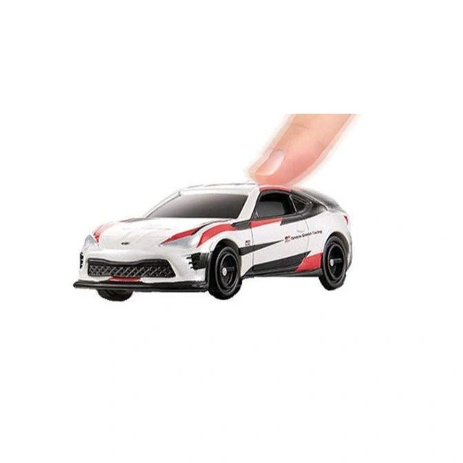 White toy GR86 race car with red and black accents, finger on top.