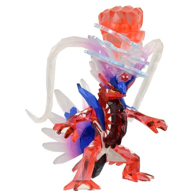  Koraidon Terastal Form toy figure, red crystal body, blue accents, crystal crown, and white tail-like appendages.
