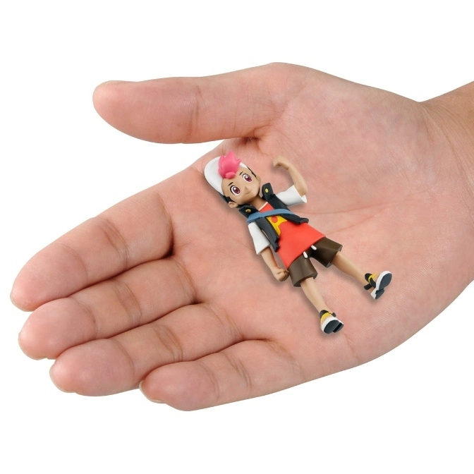  A small figurine of a boy with a white hat and pink hair, lying in the palm of a hand.