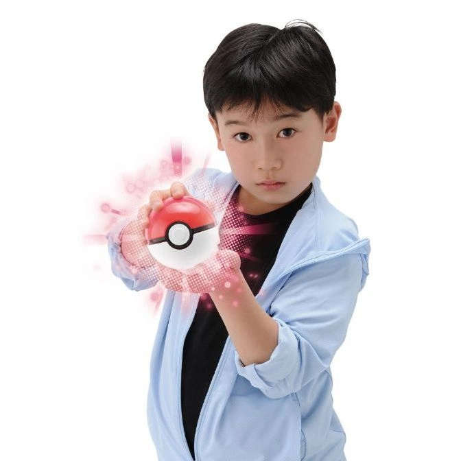  Child holding a Poké Ball with special effects, red and white toy.