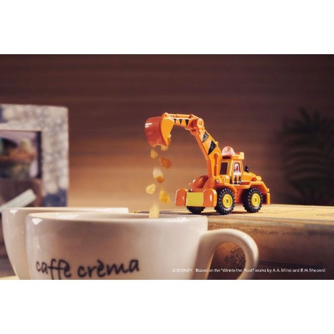  Toy excavator dumping cereal into a coffee cup.