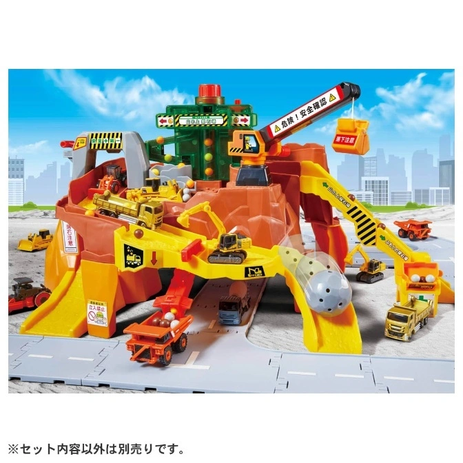 Construction toy set with cranes, trucks, and a simulated rock quarry.