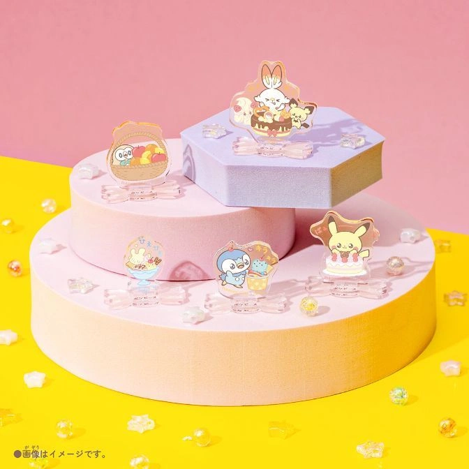  Pokémon acrylic stands on tiered platforms with pastel background. Cute character designs.