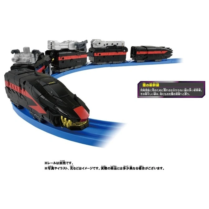  Black toy train with red accents and monster face on blue track.