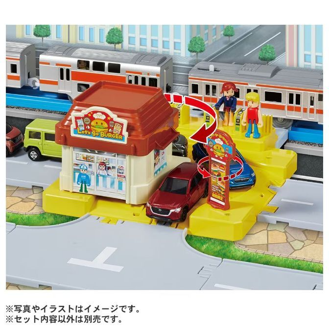  A toy set featuring a burger restaurant, cars, trains, and figures.