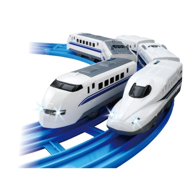 Toy bullet train set on blue tracks, featuring multiple white train cars with blue stripes and illuminated headlights.