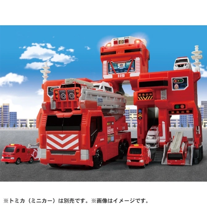 Red toy fire station with trucks. Features a tower, garage, and ladder truck. "119" and "BIGFIRE" are visible.