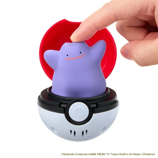  Ditto toy in a Poké Ball being touched by a finger.
