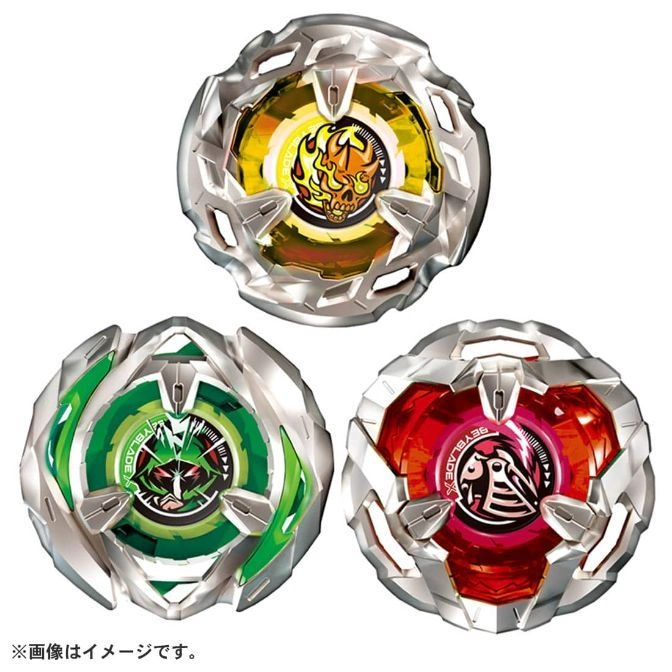 Three Beyblade X tops: yellow skull, green monster, red bird. Silver outer layer.