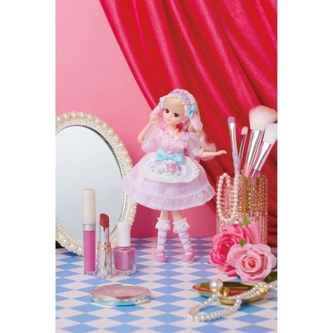  Licca-chan doll in pink dress with makeup and mirror on blue checkered table.