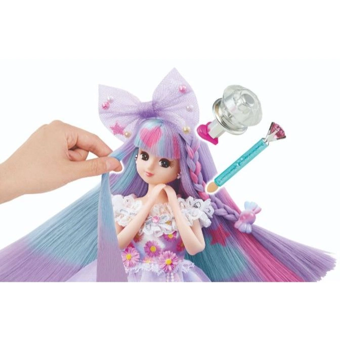 Doll with colorful hair being styled with accessories, including a bow, wand, and applicator.