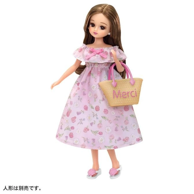  Doll in floral dress holding a "Merci" bag and wearing sandals.