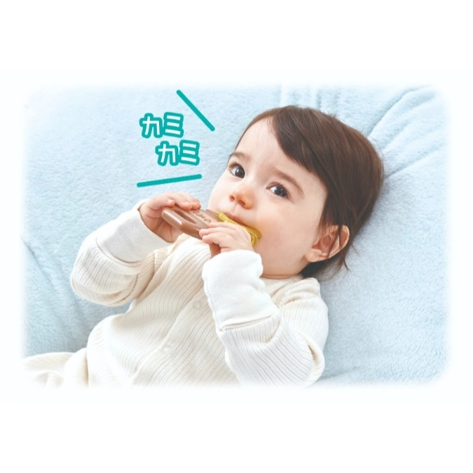  Baby chewing on a brown teether toy while lying on a blue blanket.
