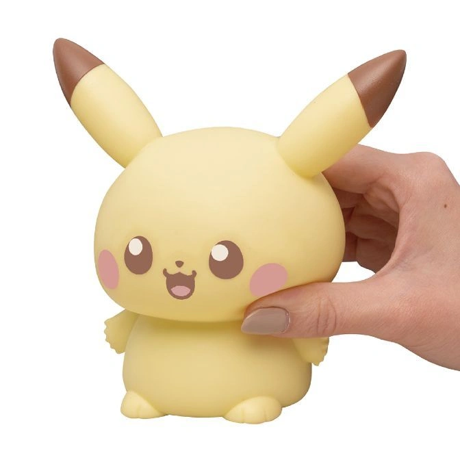  Pikachu-shaped squishy toy with brown-tipped ears being held.