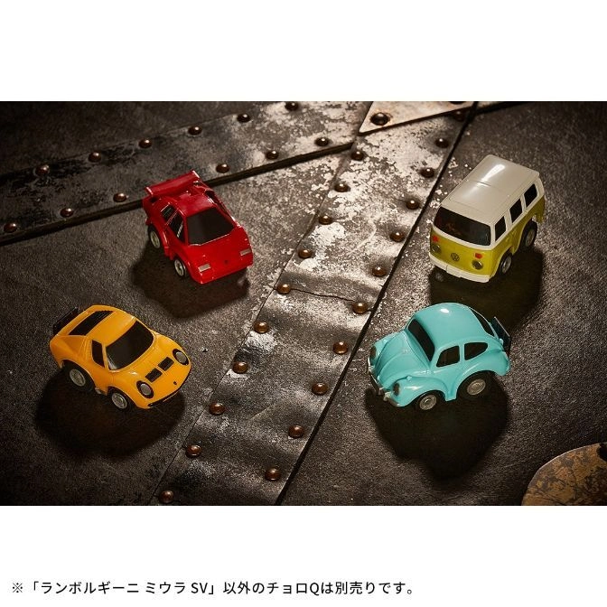  Four toy cars: yellow Lamborghini, red Countach, blue Beetle, and white/yellow VW bus on a metal surface.