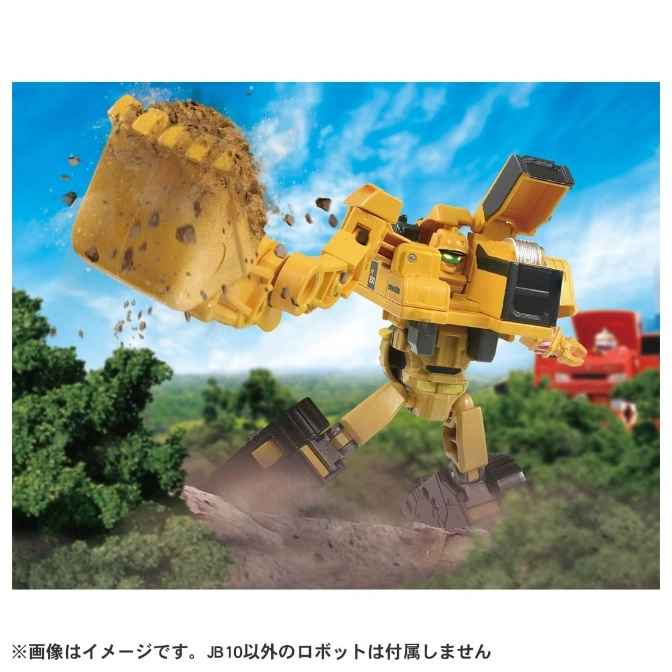  Yellow robot toy excavator with dirt in its bucket, posed dynamically in a landscape setting.