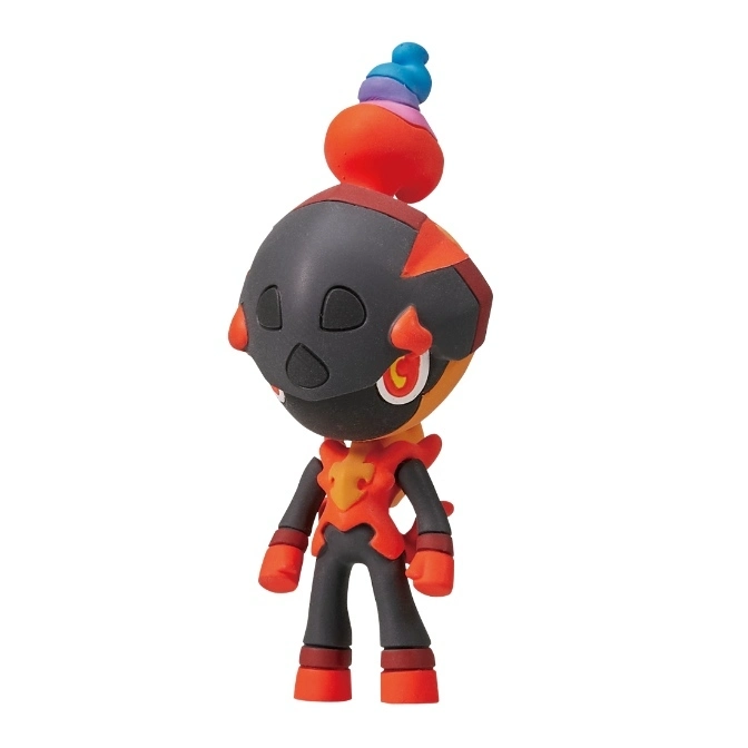 Charcadet toy figure with a black mask-like face, orange body, and colorful flame on top.