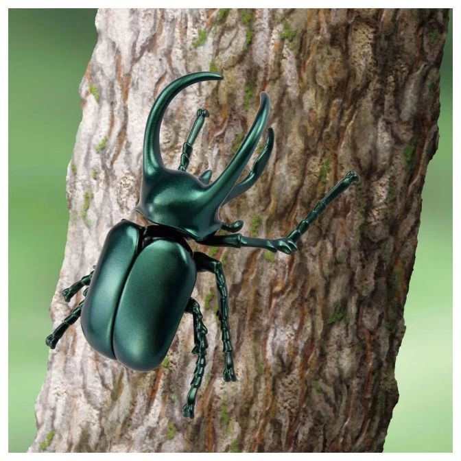  Green beetle toy with large horns climbing a tree trunk.