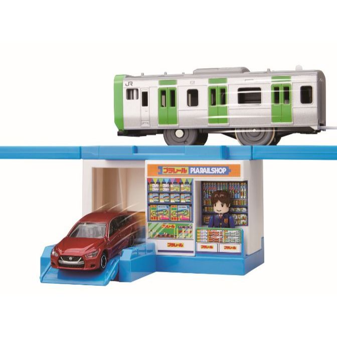  Toy train set with a red car, a train, and a shop.