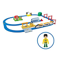 PLARAIL playset with blue oval track, station platform, tunnel, and train accessories.