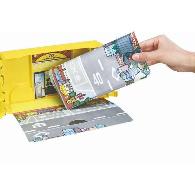  Yellow Hato Bus toy with a playmat being pulled out, showing a city road scene.