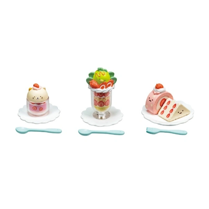  Toy desserts: cat pudding, parfait, and roll cake with utensils on white plates.