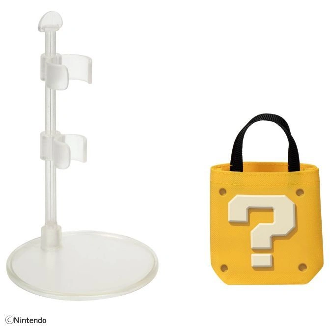  Mario toy stand and yellow question block tote bag with black handles.