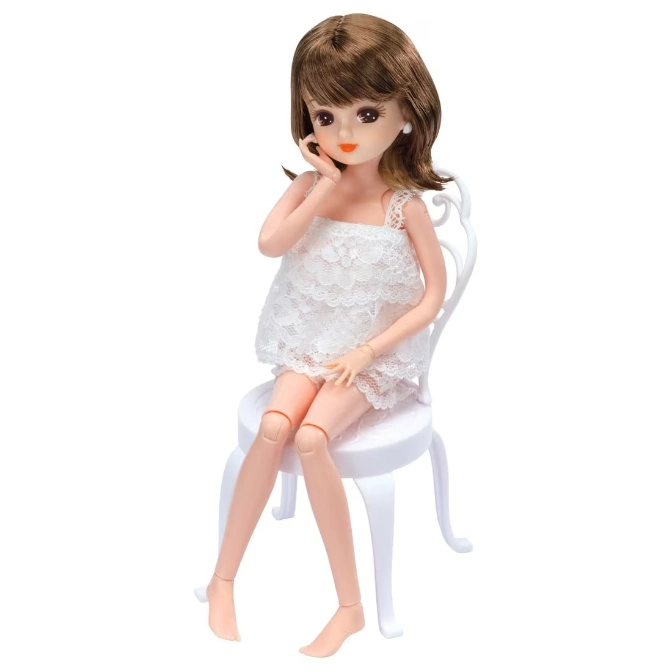  Licca-chan doll in a white lace dress sitting on a white chair.