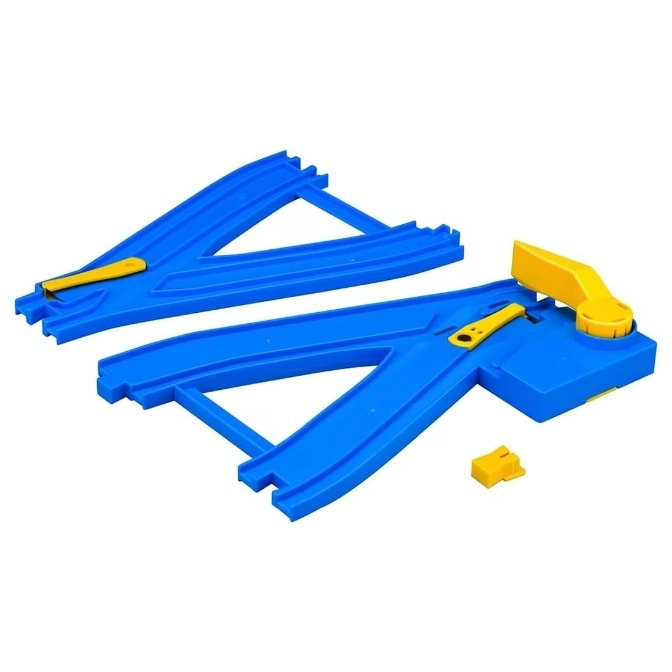 Blue toy train track with yellow switches, set to divert trains.