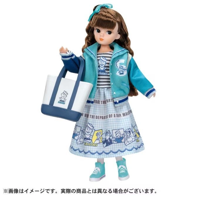 Doll with brown hair, blue jacket, sailor-themed dress, and tote bag.