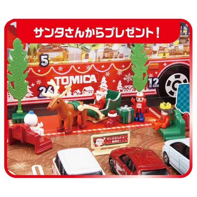  Tomica Christmas advent calendar with Santa, reindeer, figures, cars, and festive decorations.