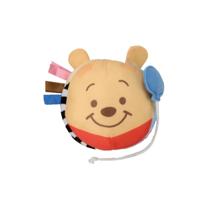 Winnie the Pooh plush toy with ribbons and a blue balloon attachment.