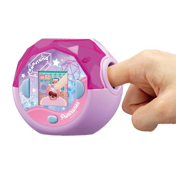  Pink Punirunes toy with a finger inserted, showing a character on screen.