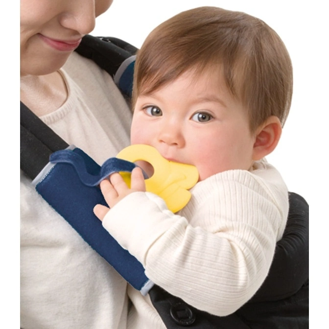  Baby in carrier chews on yellow teether attached to strap.