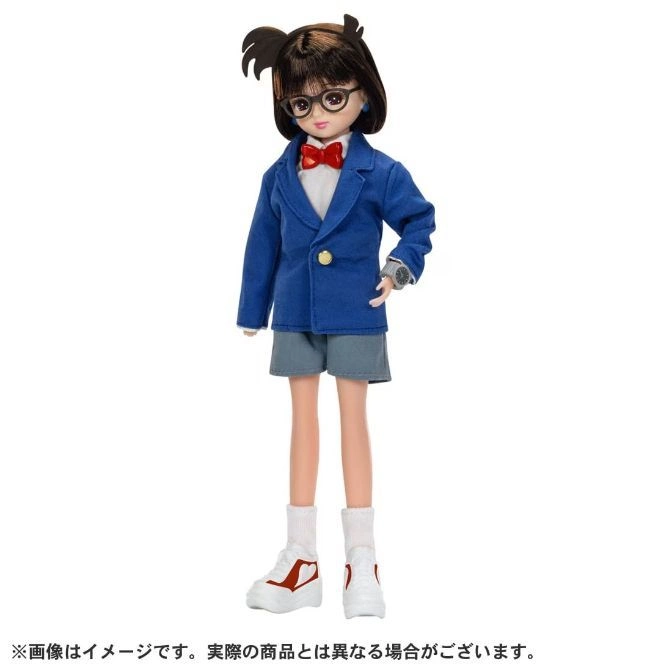 Conan Edogawa doll with glasses, blue blazer, shorts, red bow tie, and white sneakers.