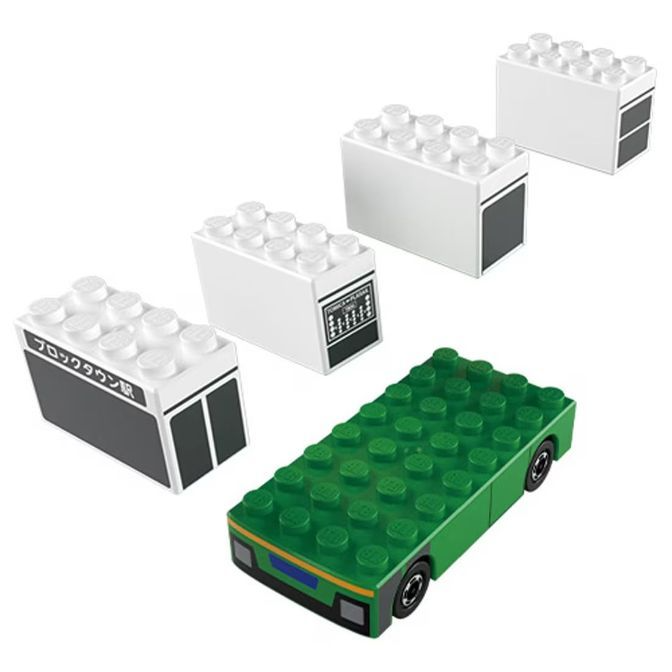  LEGO block town set with a green car and three white buildings.