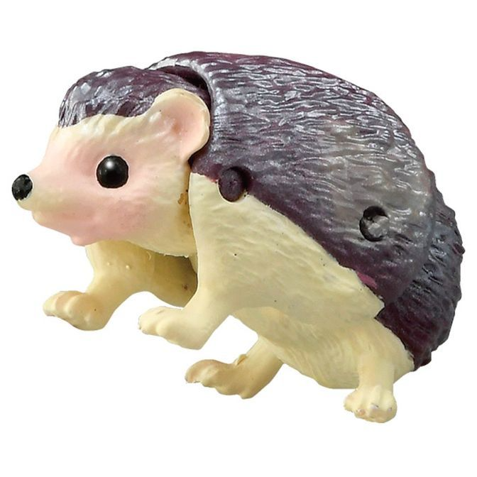  Toy hedgehog with purple quills, cream-colored face and legs, and black eyes and nose.