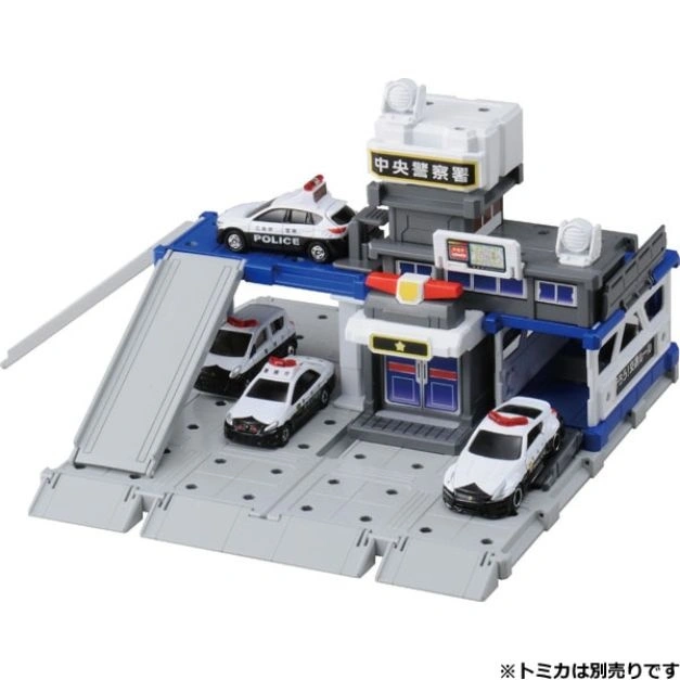 Toy police station with ramp, parking, and four toy police cars.