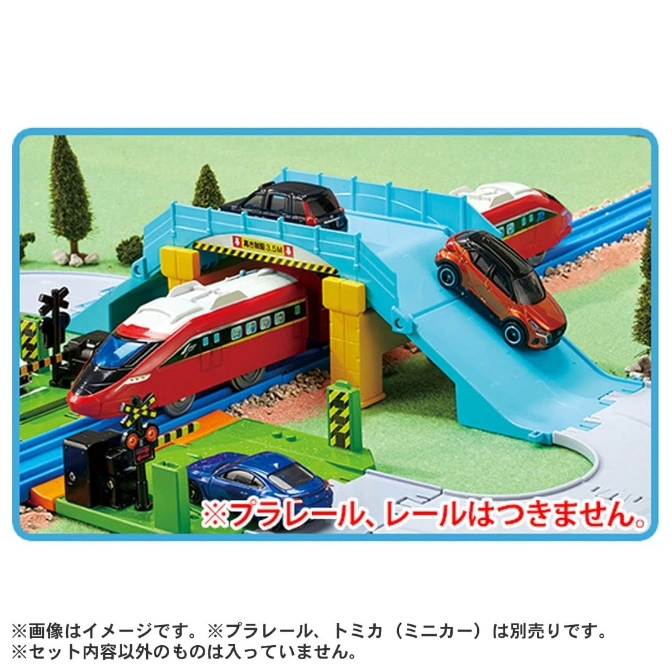  Toy train set with bridge, cars, and train. Red and white train is passing under the bridge.