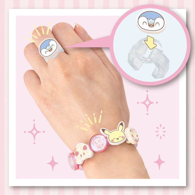  Pokémon toy jewelry: Piplup ring and Pikachu charm bracelet on a hand.
