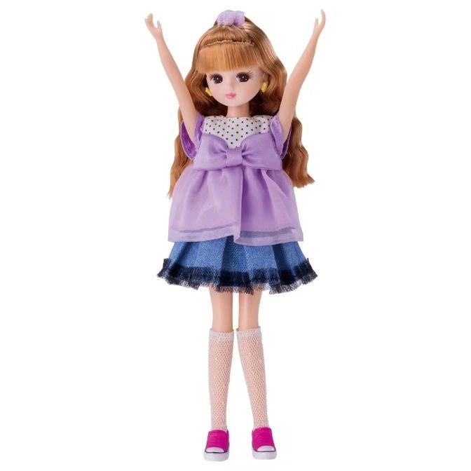  Doll with auburn hair in a purple dress, denim skirt, knee socks, and pink sneakers, arms raised.