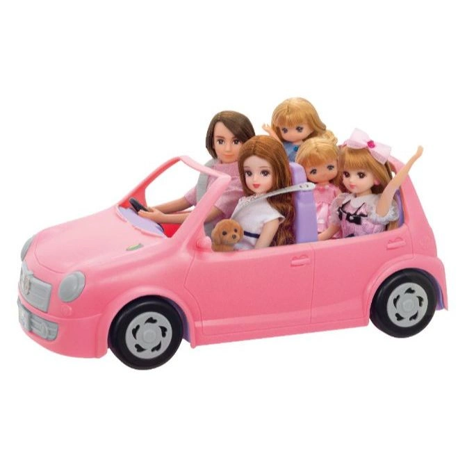 Pink toy car with five dolls and a dog inside, ready for a fun ride.