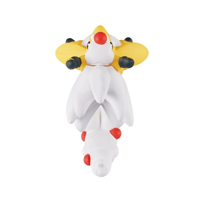  White and yellow Togepi-like toy with red accents and black feet.