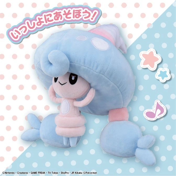  Light blue plush Pokémon Morelull toy with pink accents, smiling on a polka dot background.