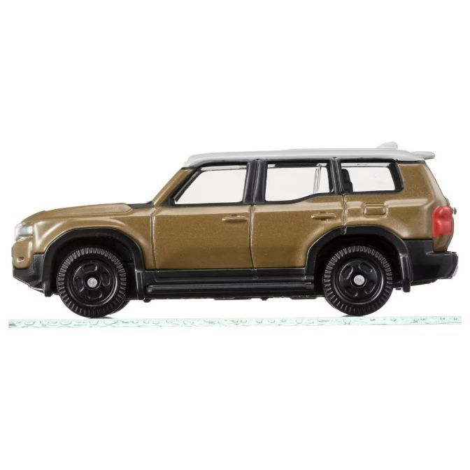  Bronze toy SUV with black wheels and a white roof.